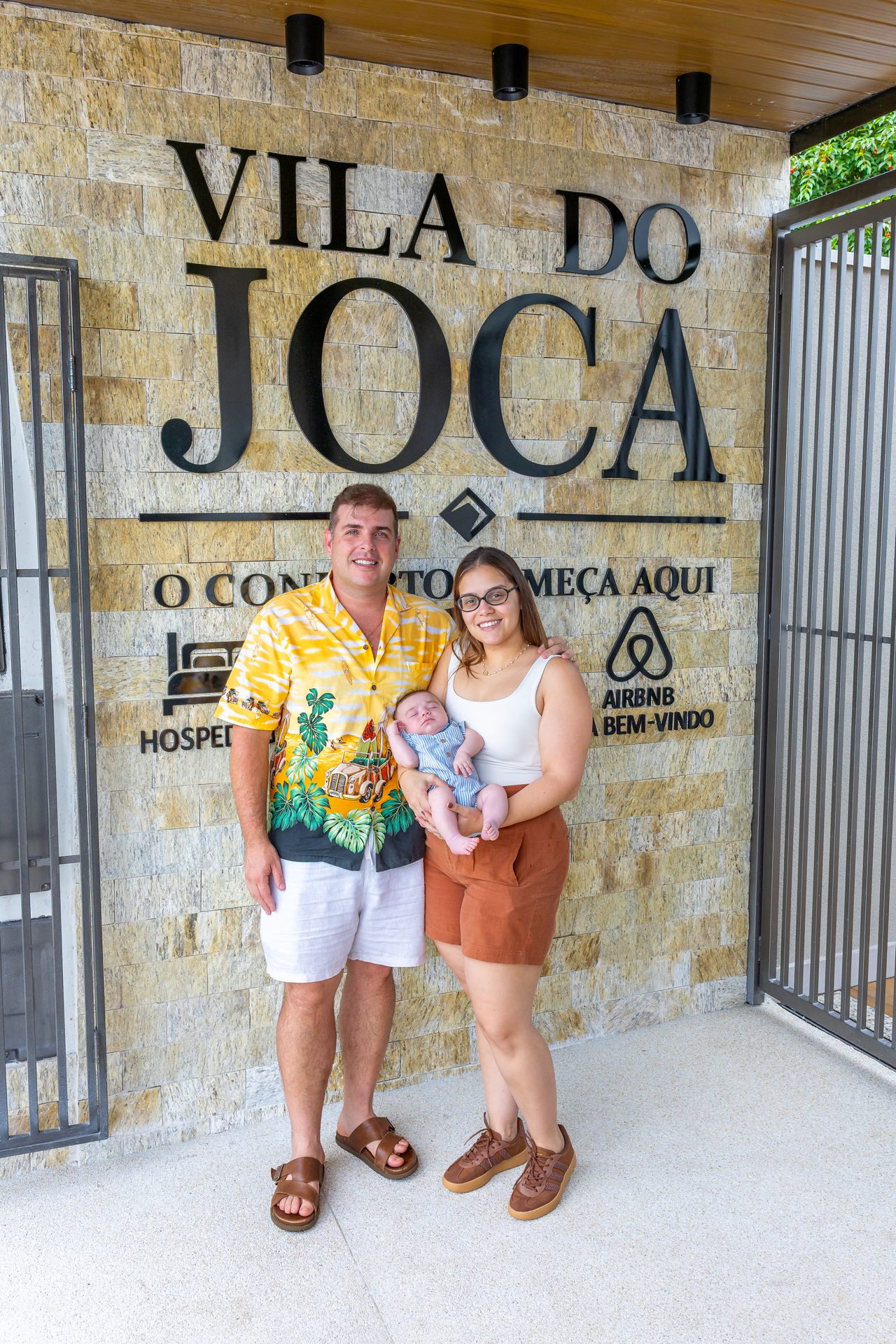 Os donos da Vila do Joca com o filho Joaquim, o Joca, em frente ao letreiro